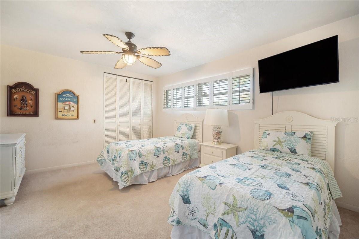 A spacious guest room flooded with natural lighting.