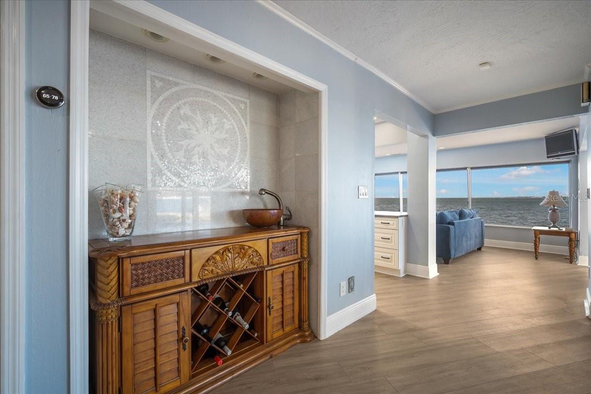 In this dining area is a sizable alcove that leads to the kitchen area and still showing the stunning water views.