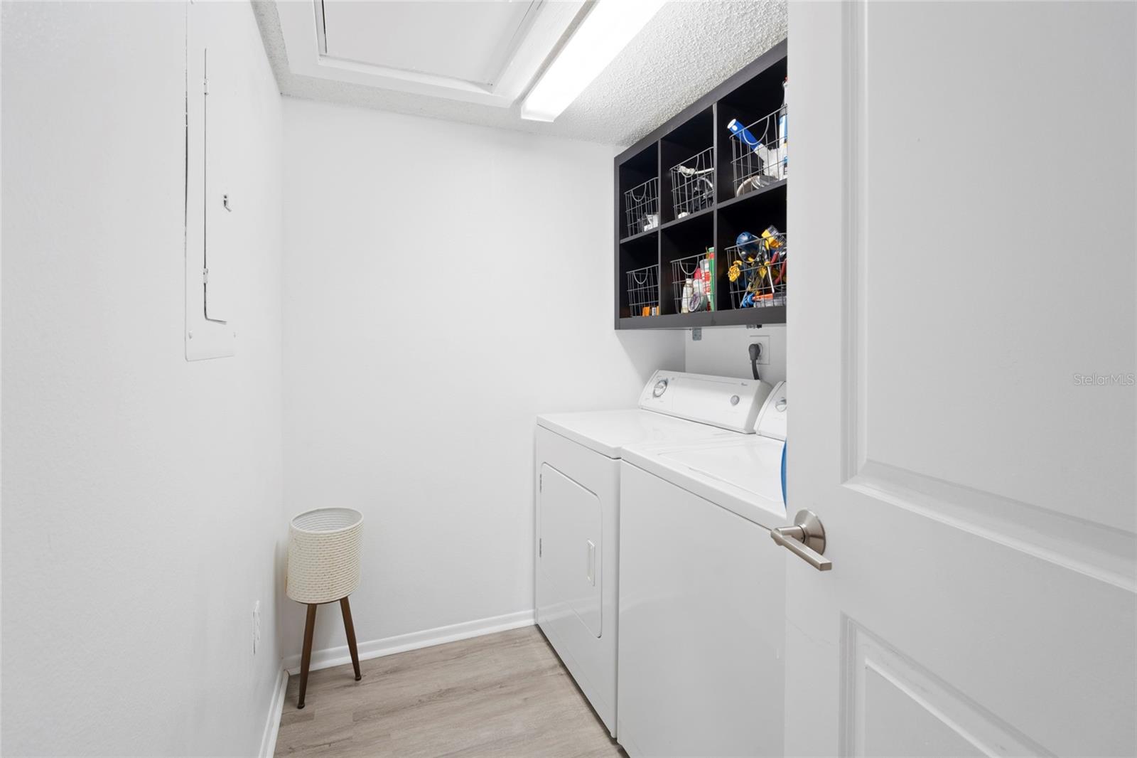 Laundry room with attic access and storage