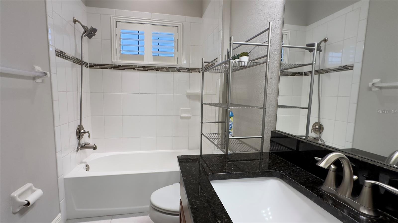 As with the rest of the bathrooms, granite counter tops and brushed nickel faucets give an elegant touchto this bathroom
