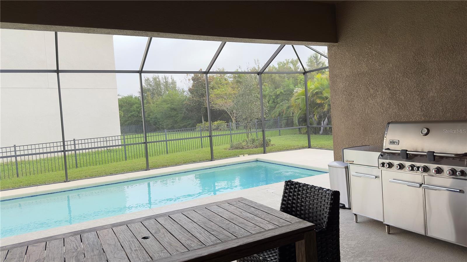 The covered and screened lanai has plenty of space for hosting a barbecue or party