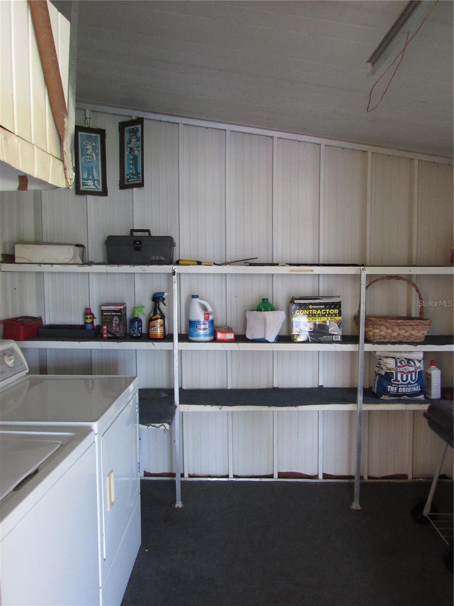 Utility room with shelving, washer and dryer.