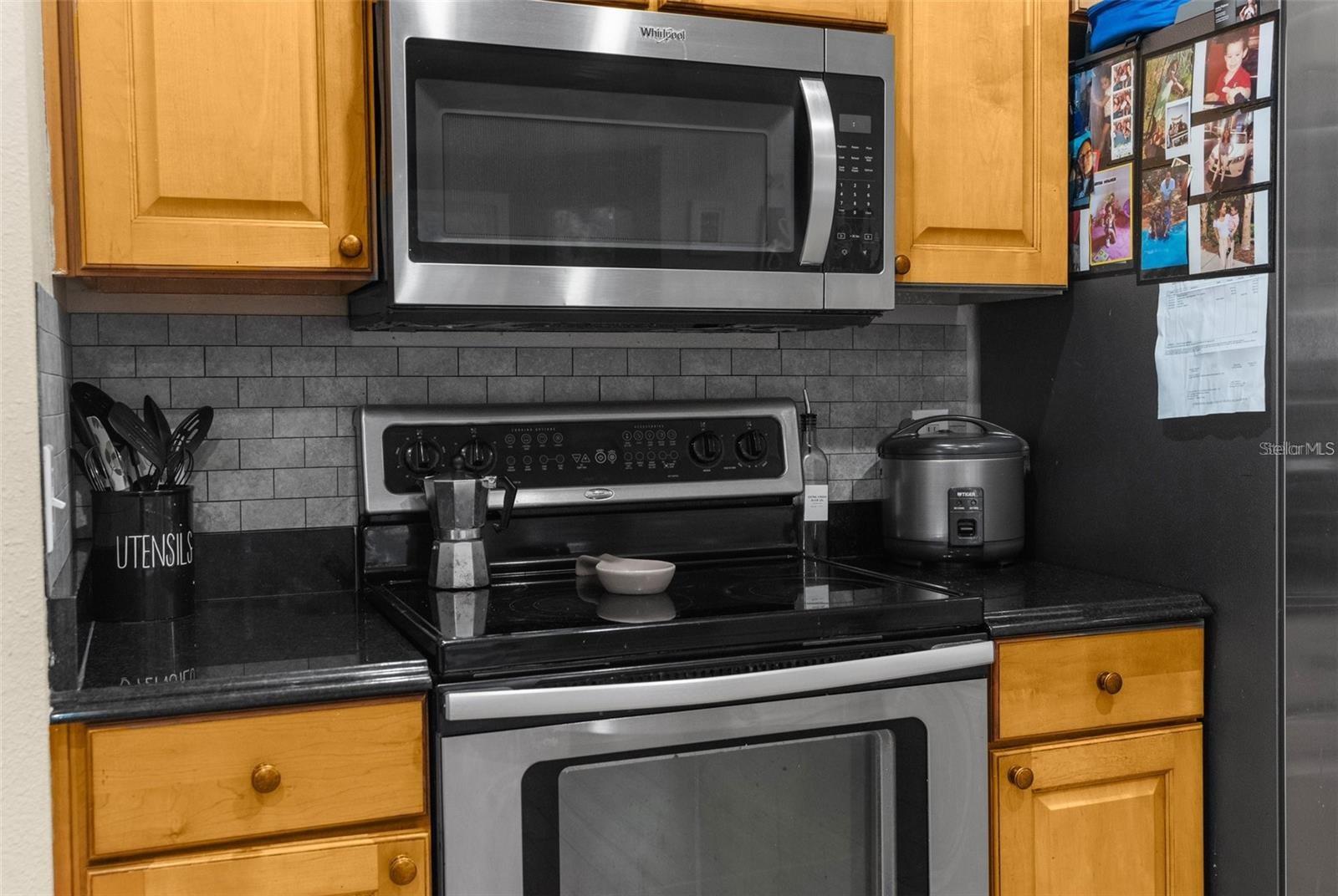 Kitchen view of range & microwave - 12119 DEERTRACK LOOP