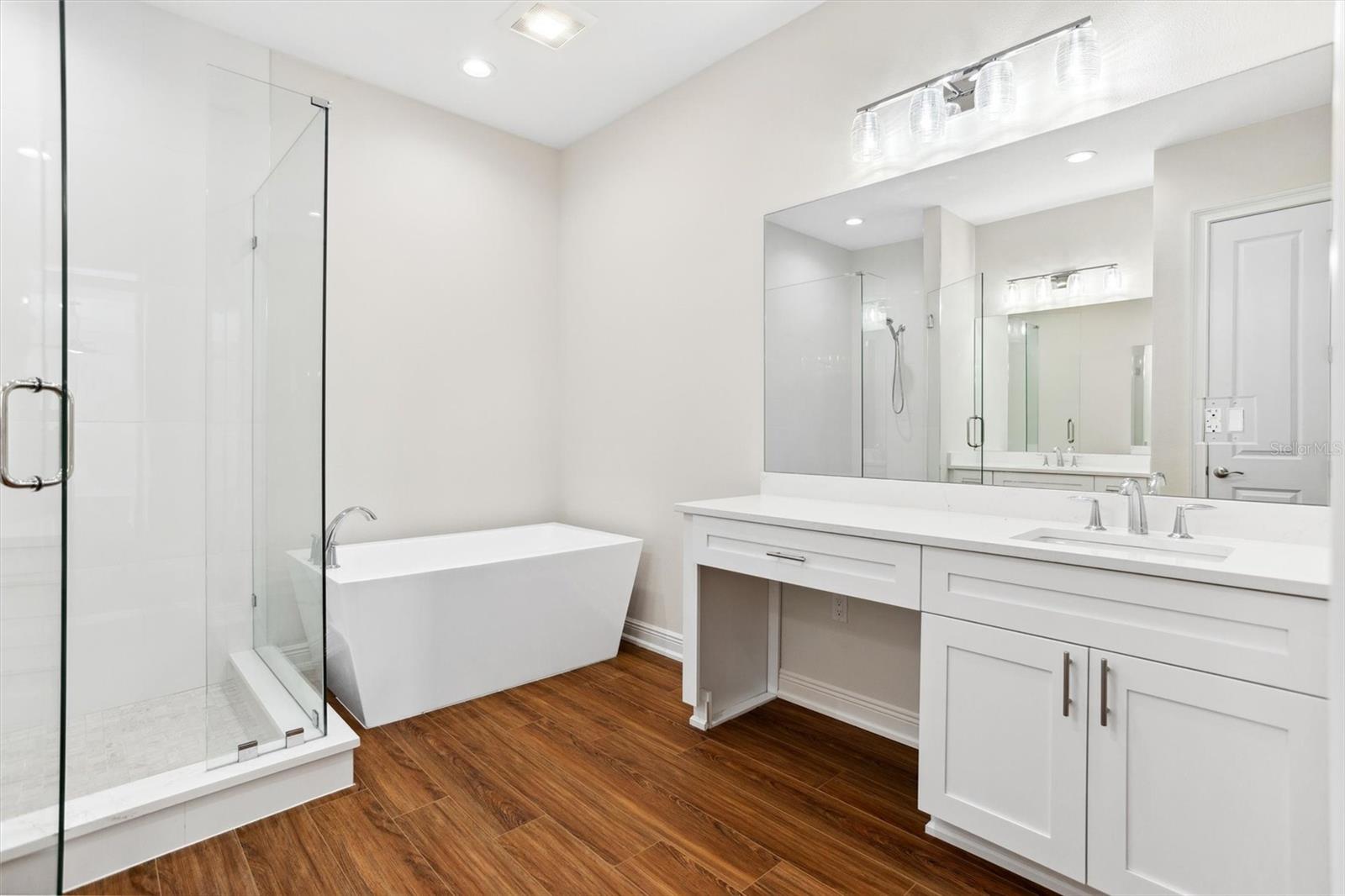 Main Bathroom with dual vanities, oversized shower, shower bench, soaking tub and separate water closet.