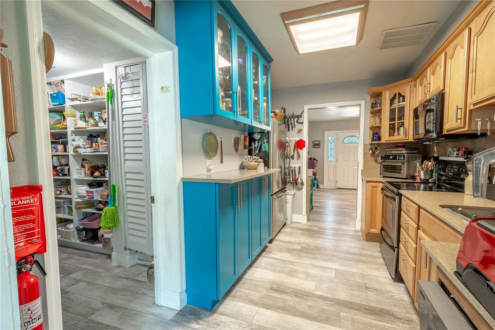 The kitchen features luxury vinyl floors, and a built-in buffet.