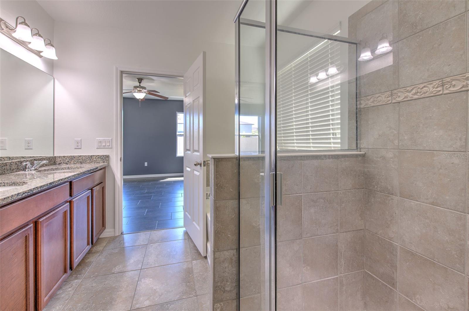 Both primary bathrooms include shower, garden tub, and dual vanity with granite counters.
