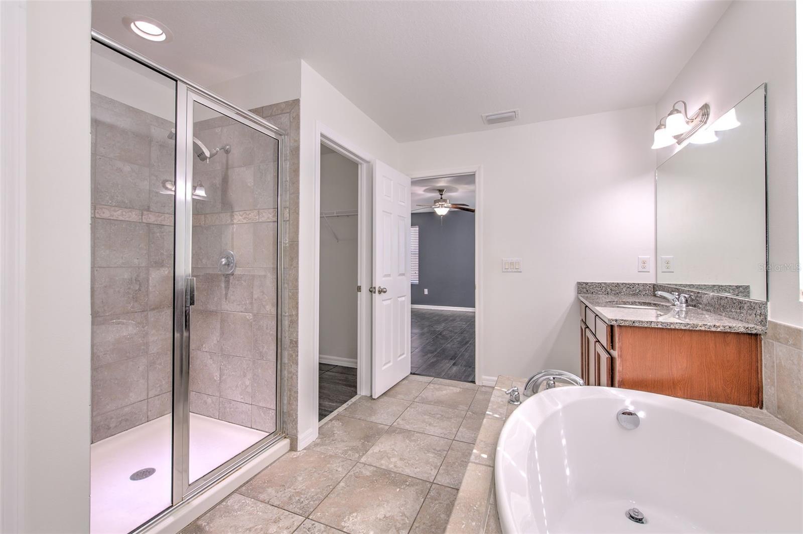 Both primary bathrooms include shower, garden tub, and dual vanity with granite counters.