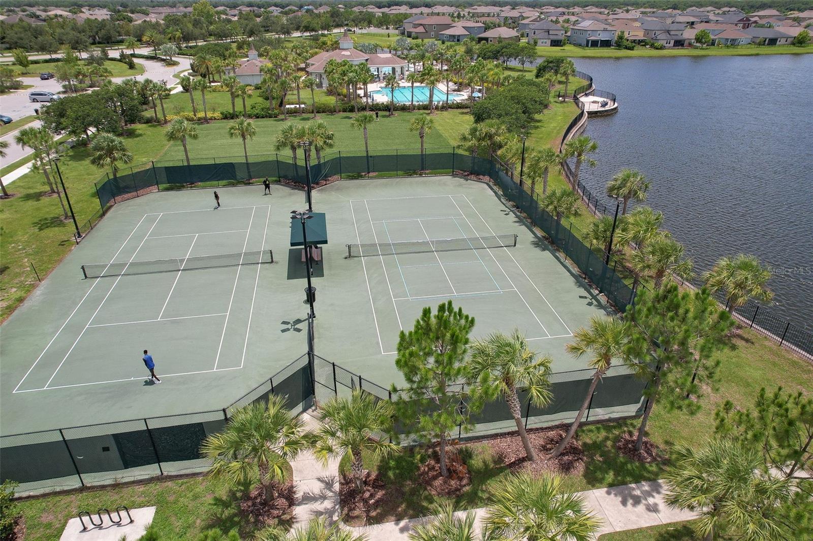 View of the double tennis courts, turfed sports field and pool complex.