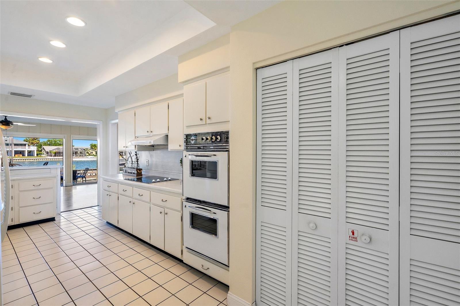 It is a testimony to how well-conceived the original kitchen was. There is a cooktop, with hood and separate double-ovens THAT STILL WORK! There is a recessed ceiling; AND, a spacious pantry measuring almost 3.5' deep by 6' wide!
