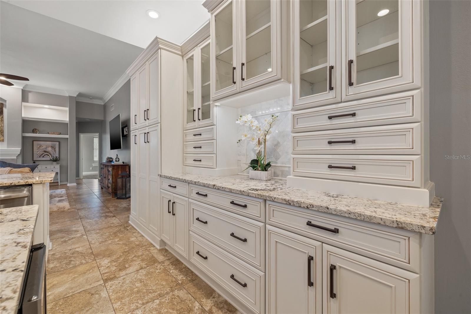 custom designed hutch in the kitchen with marble back splash.