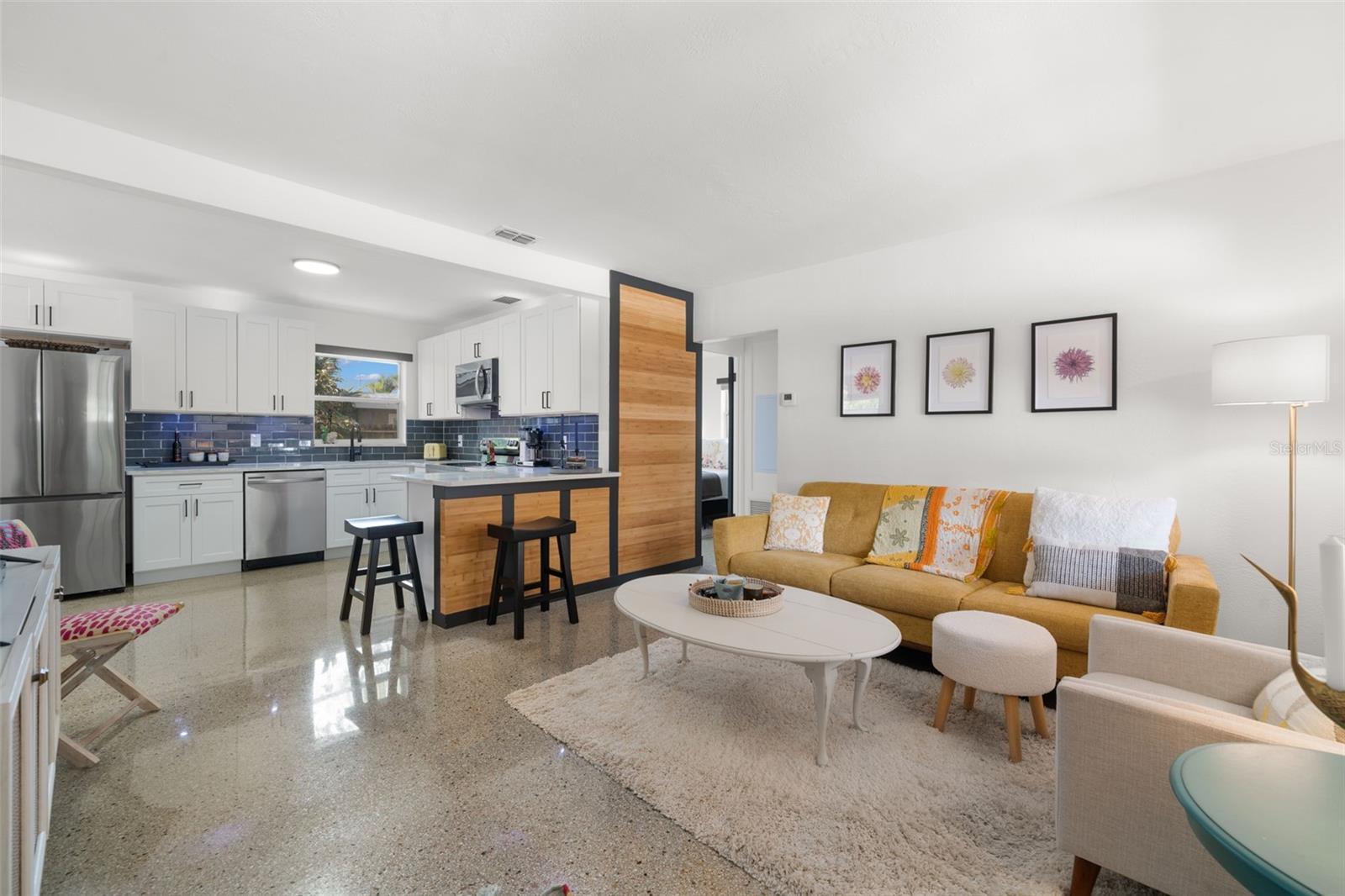 Spacious living room with sparkling terrazzo floors.