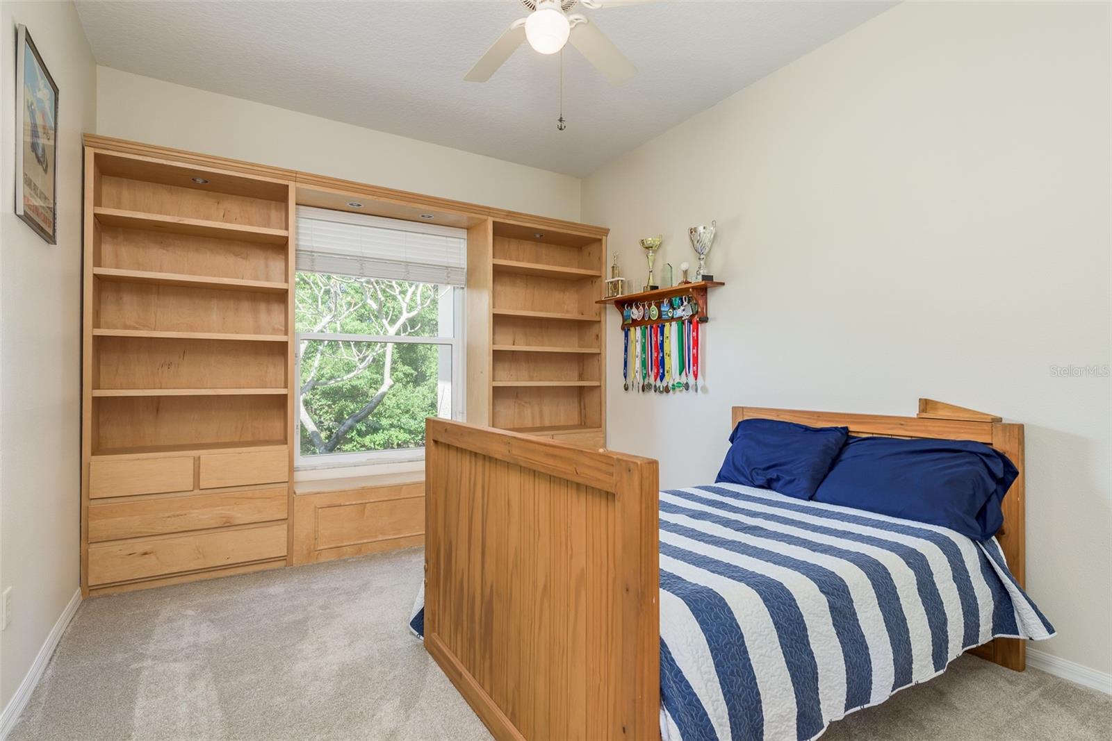 Bedroom 3 showcases a walk-in closet with built-in storage nestled within the room, offering a seamless blend of functionality and aesthetics, ensuring every inch of space is utilized efficiently while maintaining a clean and stylish interior design.