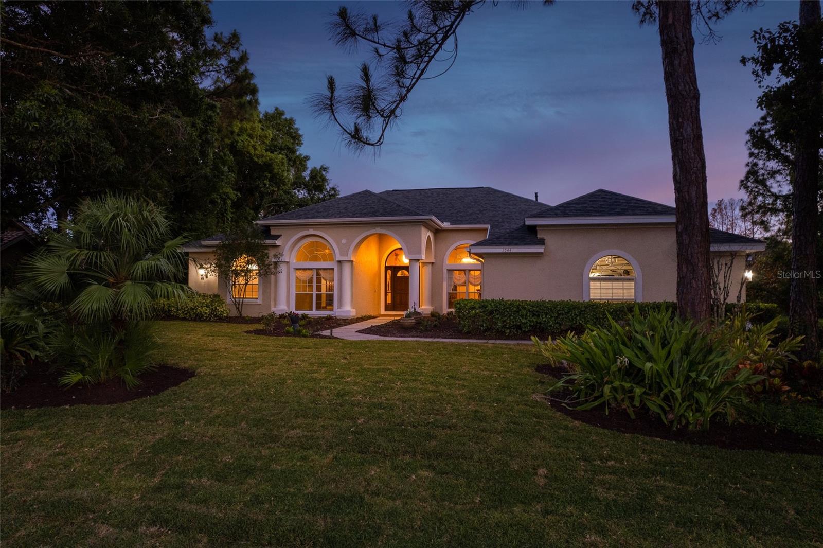 Capture the enchanting beauty of the front of your home in twilight photos, where the soft glow of the evening sky casts a magical aura over the elegant facade, creating a captivating scene that beckons with warmth and charm.