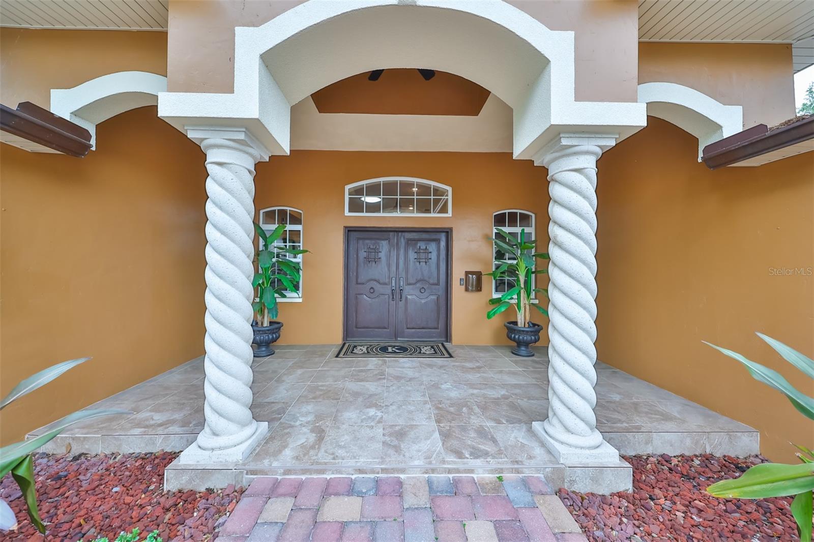 Grand entrance with solid wood double doors.