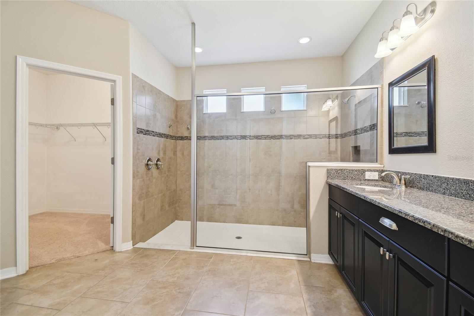 Master bathroom with entrance to walk-in closet