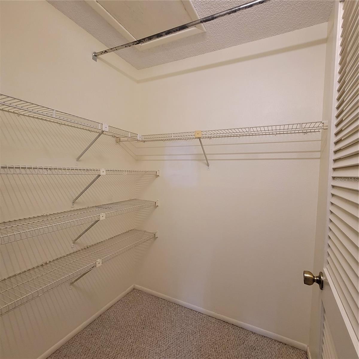 Primary Bedroom walk in closet with access to attic space