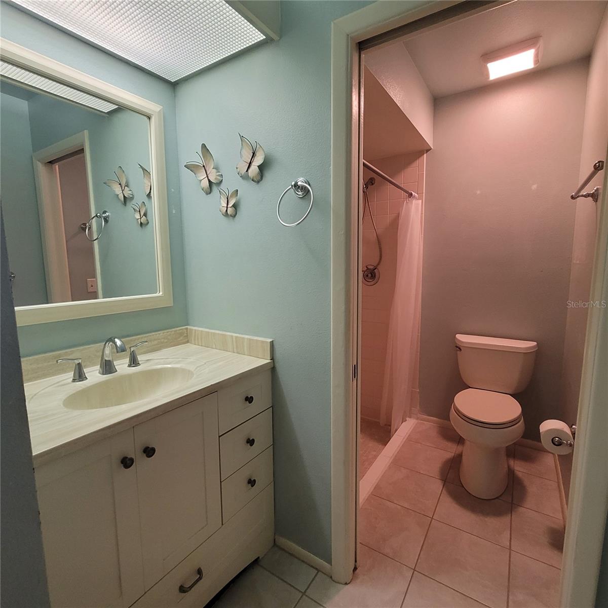 Primary Bathroom has a sliding door that offers privacy from the dressing area