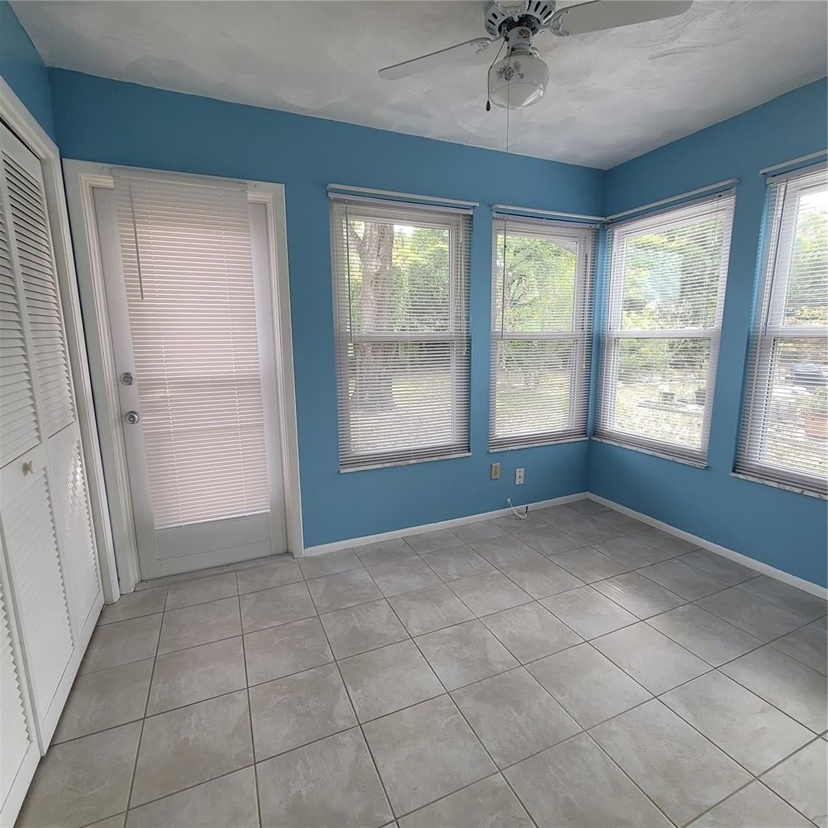 Large enclosed back porch with tile floor