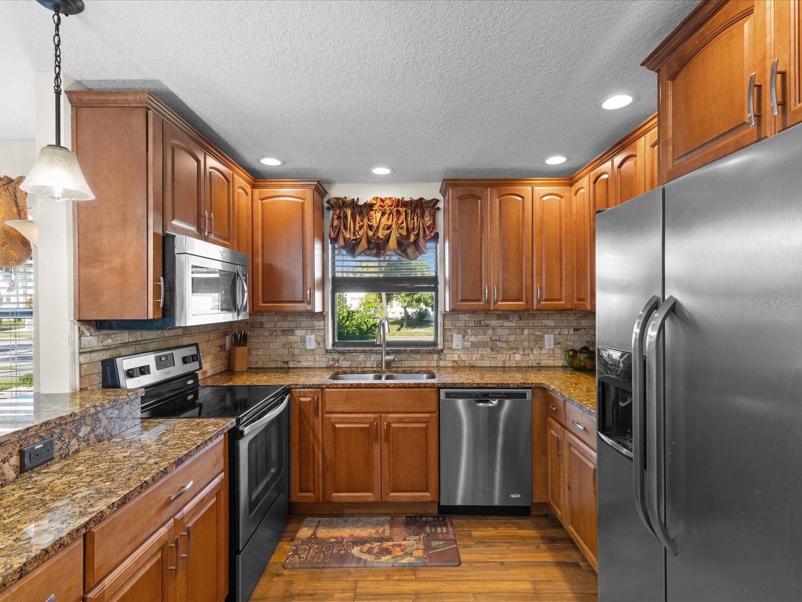Kitchen w/ wood cabinets and granite