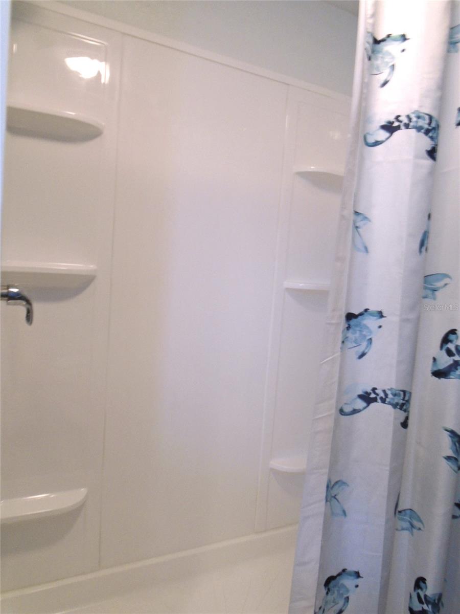 Shower in the Guest Bath has Lots of Shelves for Your Toiletries