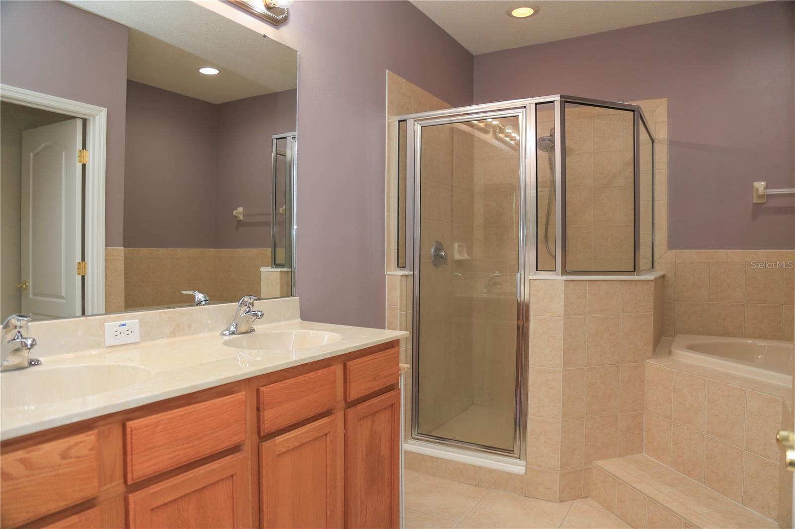 Master bathroom features dual sink vanities, cultured marble countertops, separate shower & Garden tub
