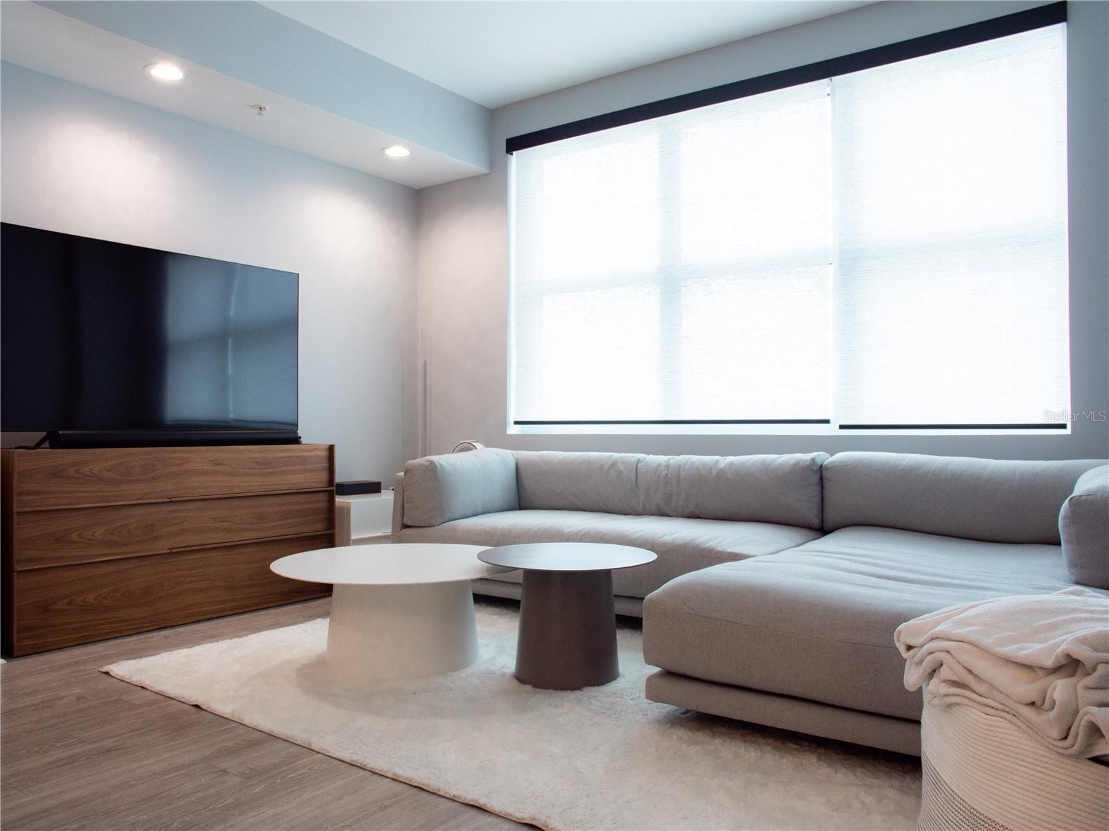 Living room space with remote control shades
