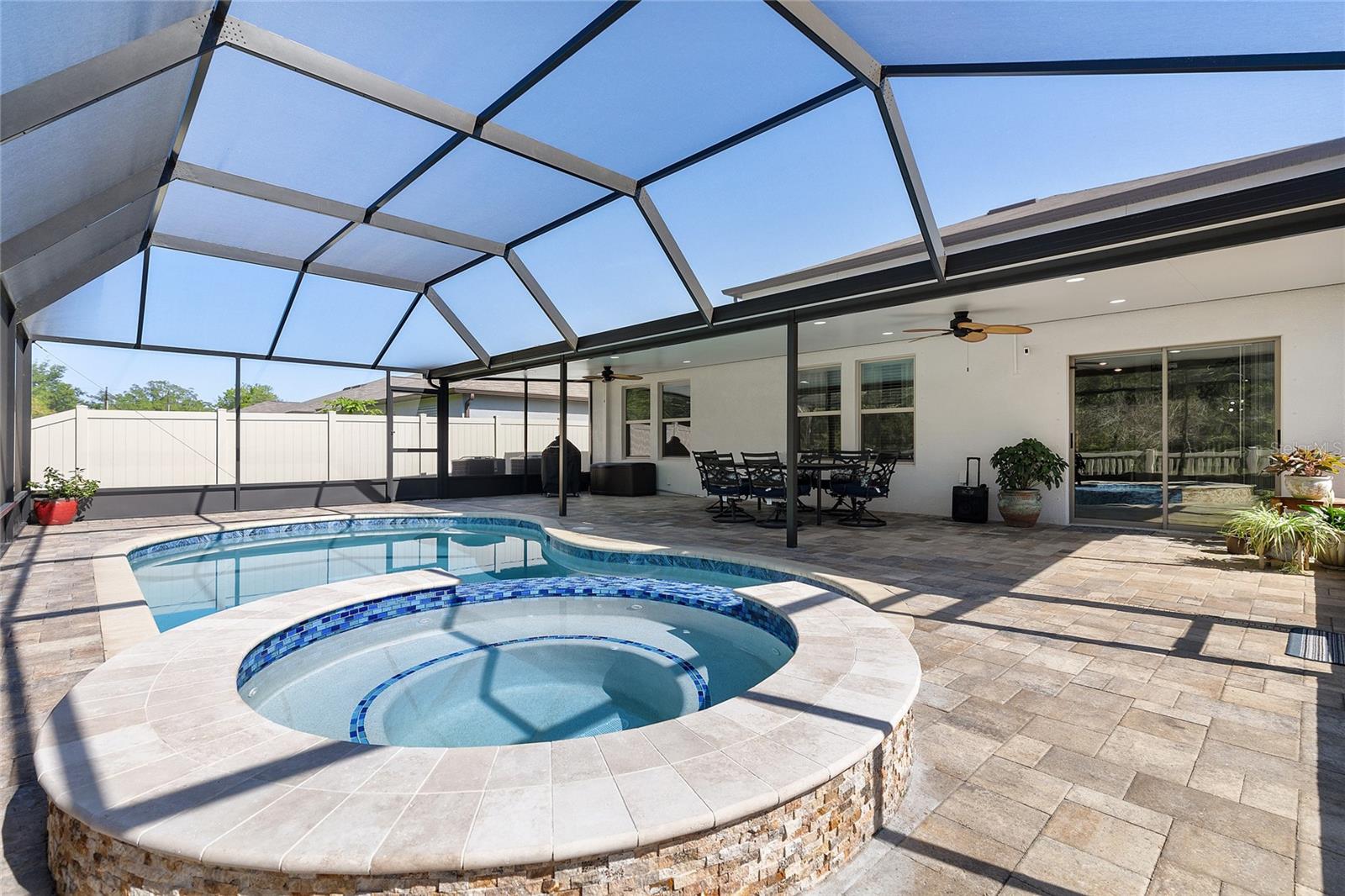 Beautiful covered patio and caged pool area