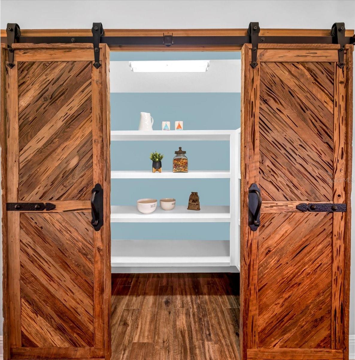 Walk-in pantry with wooden barn doors