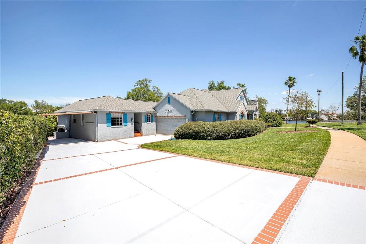 Large driveway can accommodate multiple vehicles, RV, boat.  2 car garage and 1 car carport.