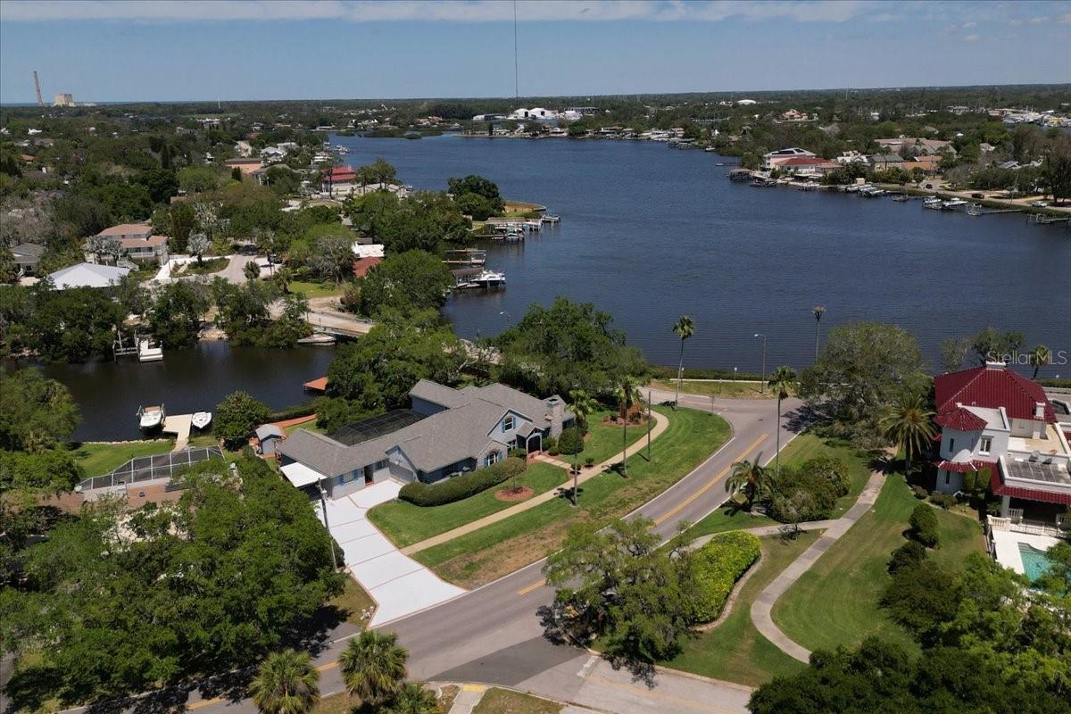 Aerial view of home on large lot with Kraemer Bayou on right and canal in rear of home