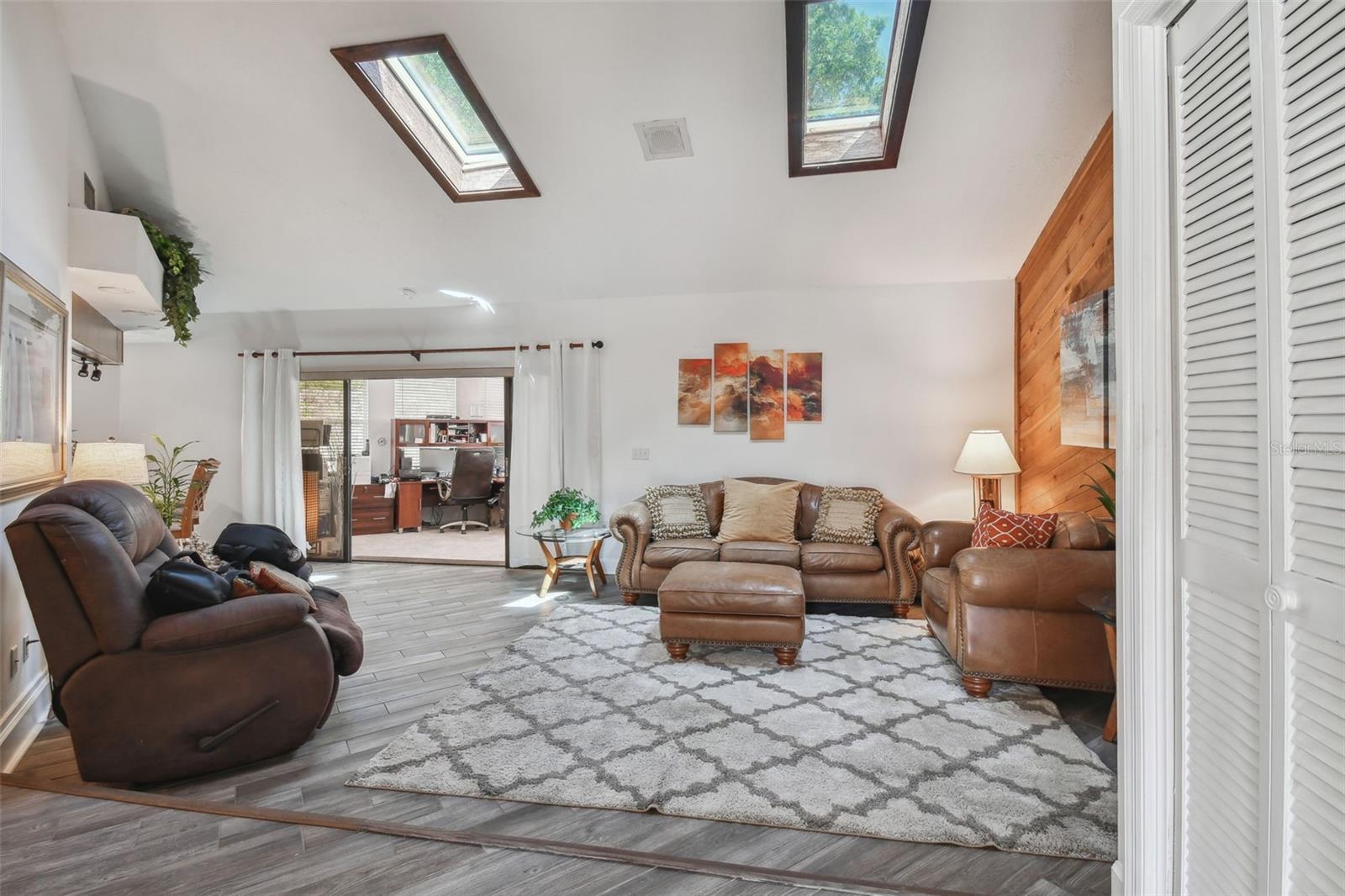 Spacious living room with skylights.