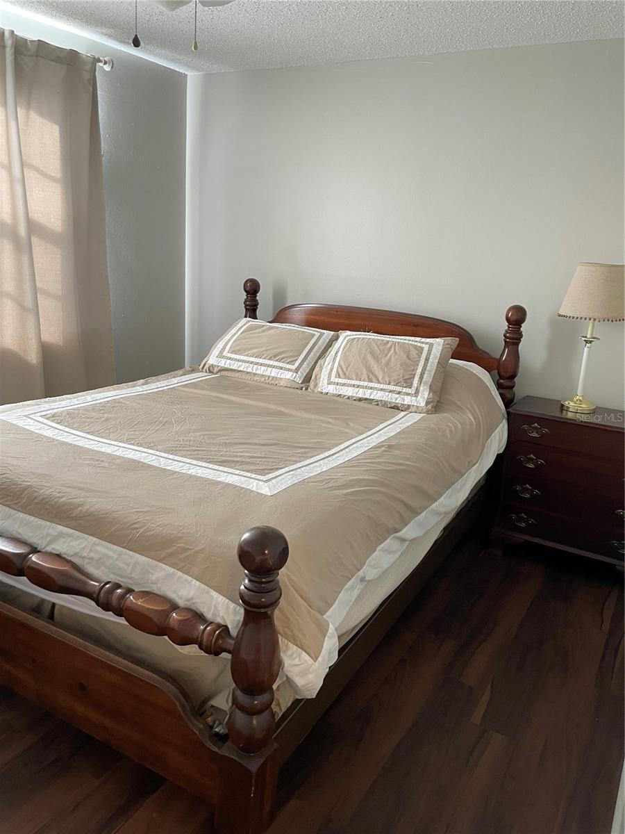 Owner's bedroom with newer vinyl plank