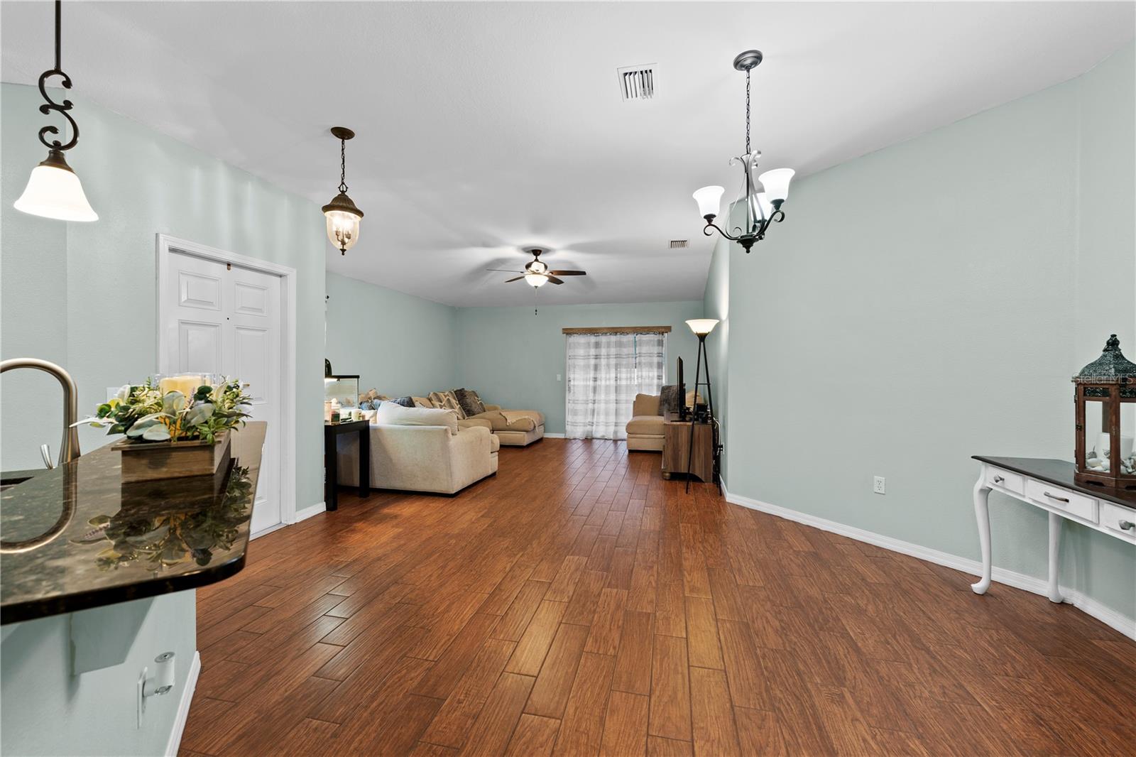 Open Concept Living & Dining With Upgraded Fixtures & Beautiful Wood Look Flooring