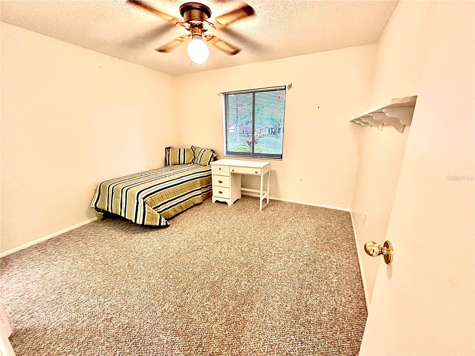 guest Bedroom. Berber carpet. ceiling fan.
