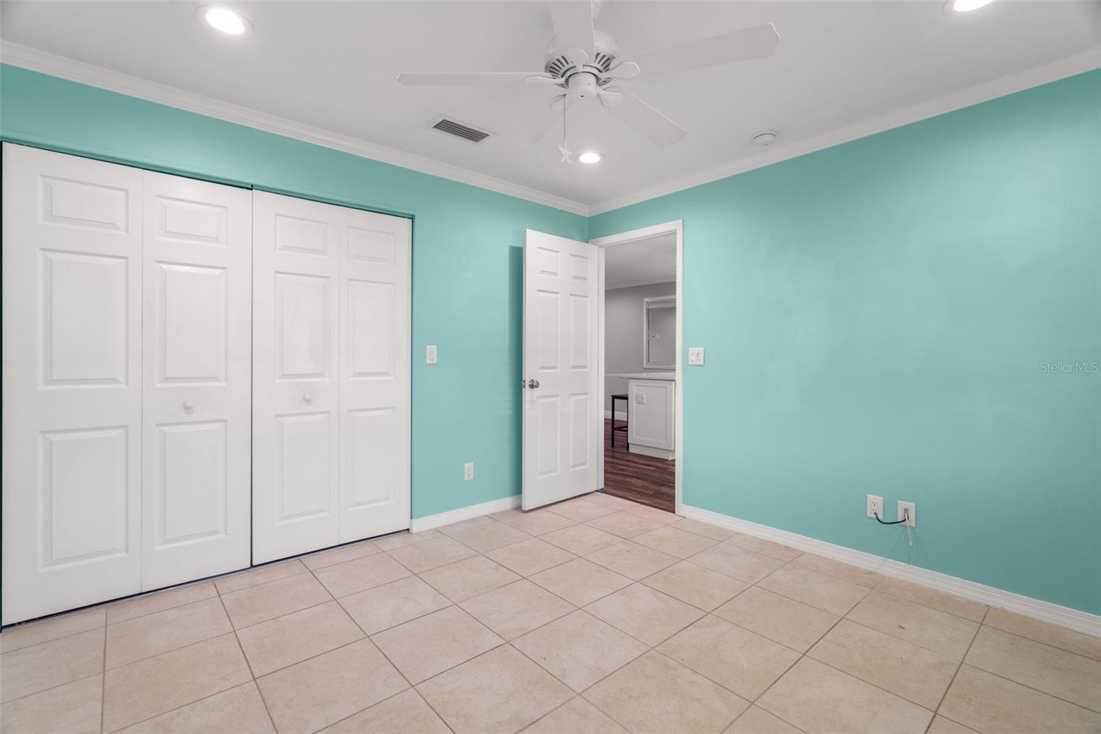 Walk through the small hallway to reach the primary bedroom, which offers generous closet space.