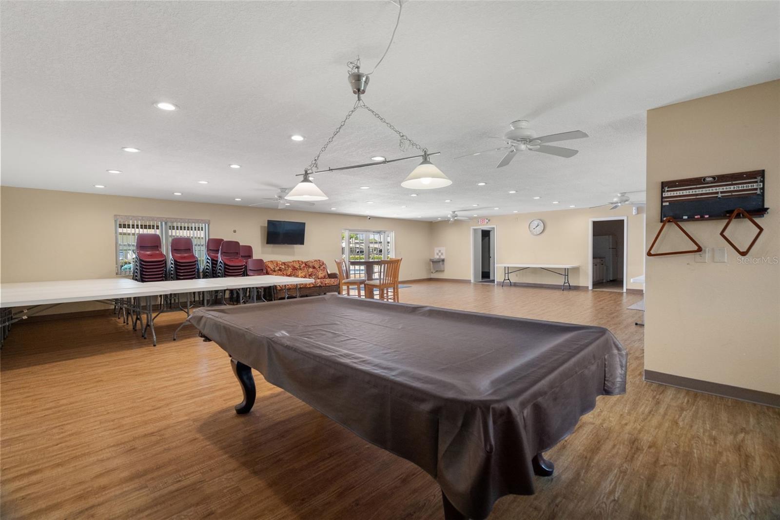 Inside the clubhouse, you'll discover ample tables and chairs, perfect for meetings or parties, along with a full-size pool table for your entertainment.
