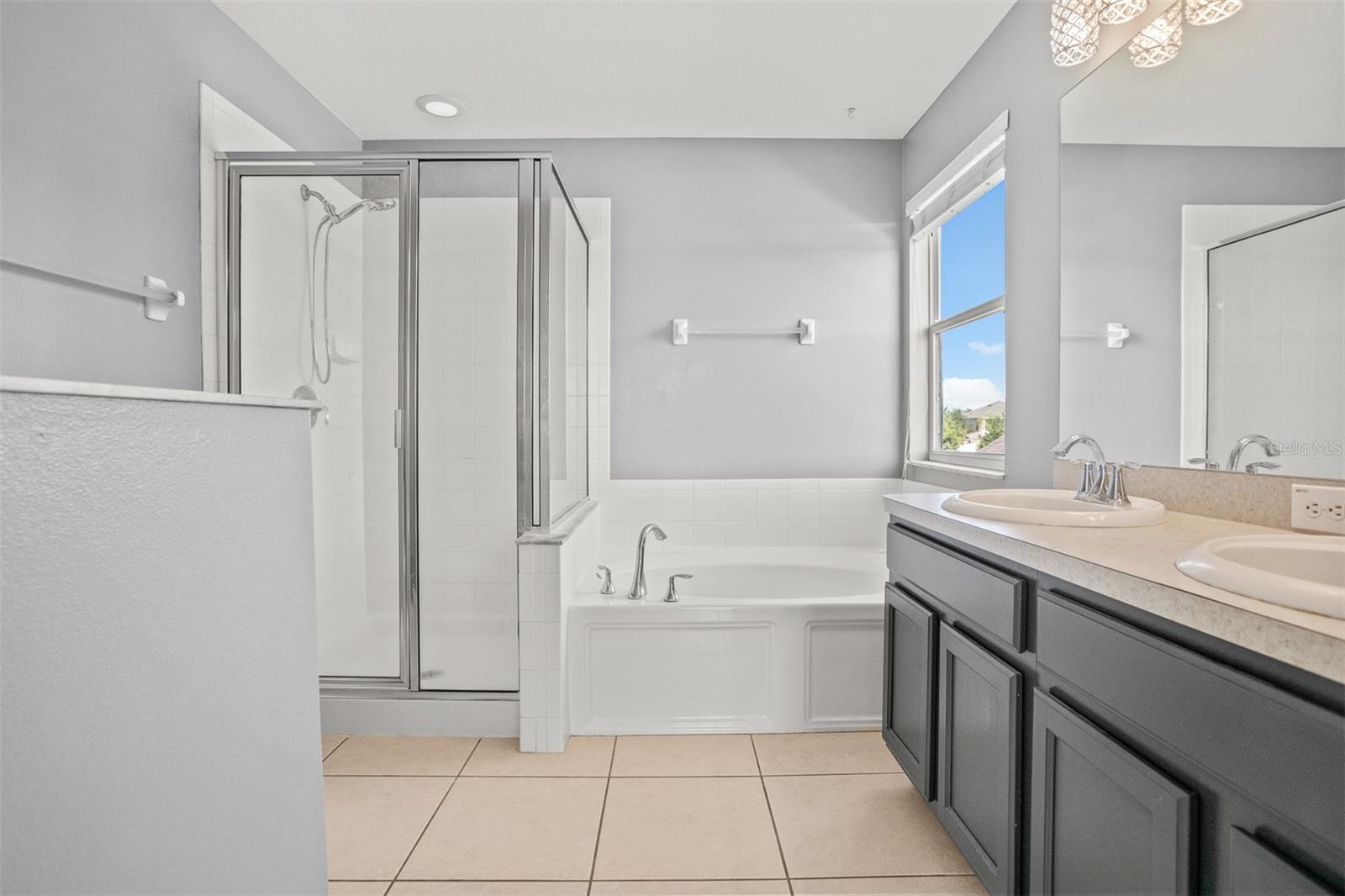 Large master bathroom with stone countertops