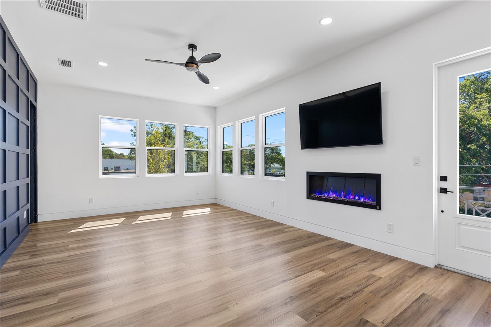 Primary Ensuite with Fireplace, TV and views of downtown Tampa