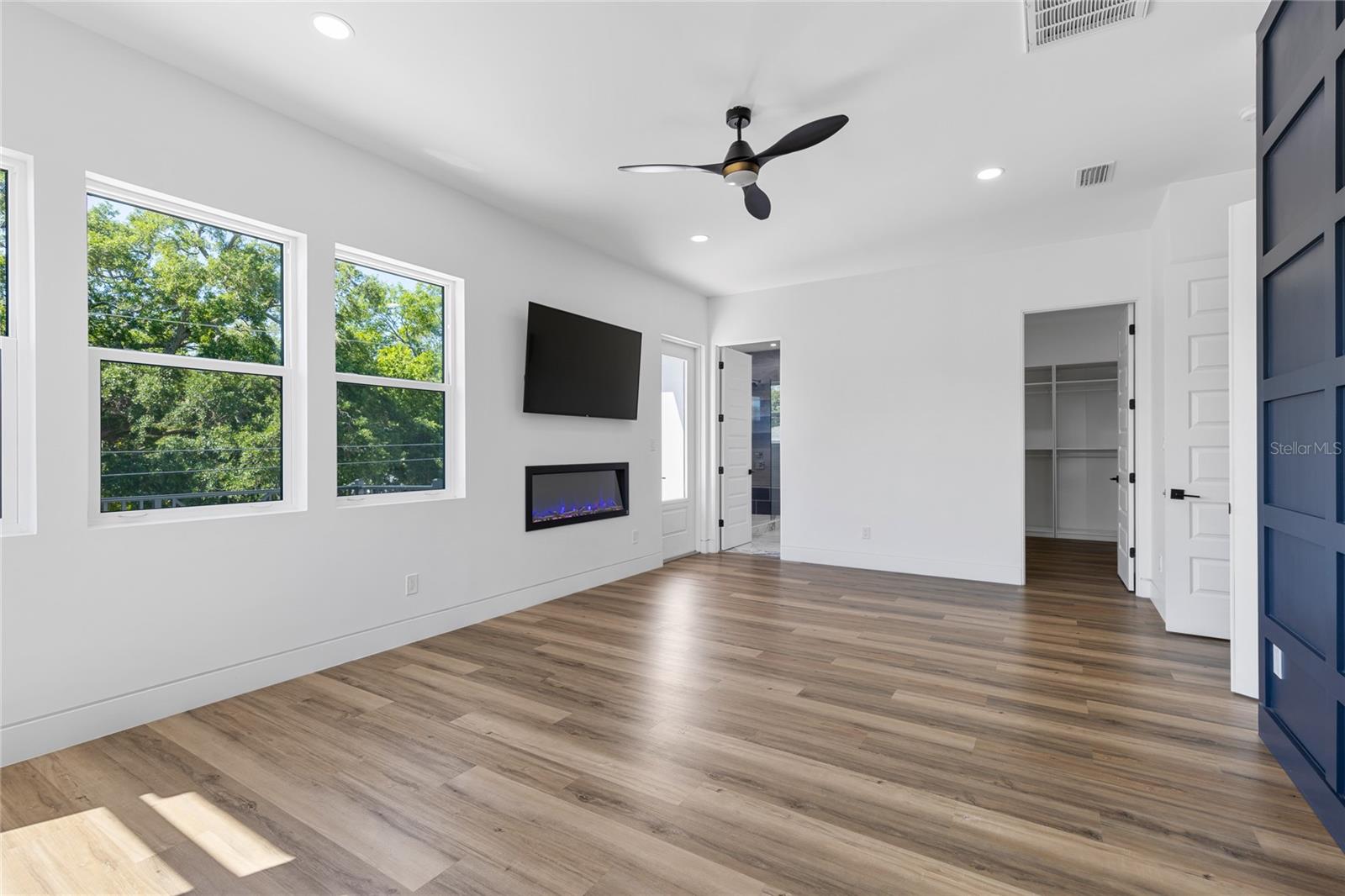 Primary Ensuite with Fireplace, TV and views of downtown Tampa
