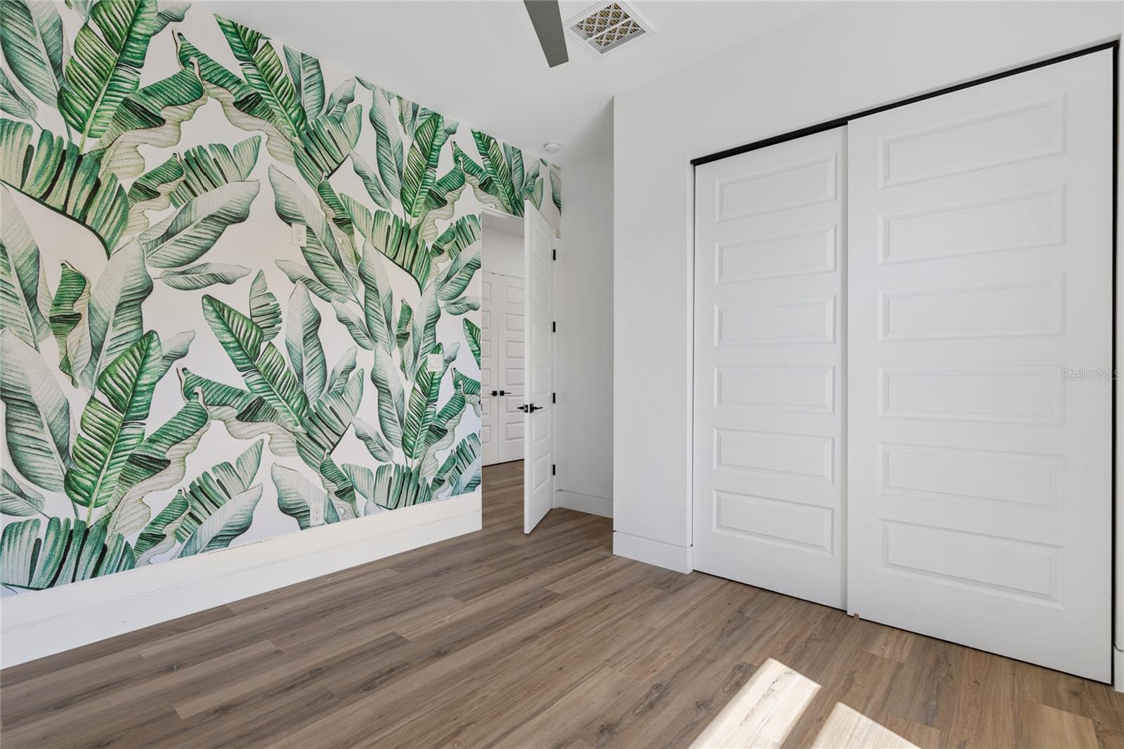 2nd bedroom with wall leaf wallpaper