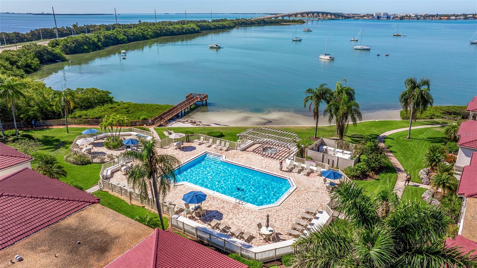 AERIAL VIEW OF THE BRIDGE TO TIERRA VERDE AND BATS MOORED ON THE BOCA CIEGA BAY. noTE THE TAMPA BAY ON THE OTHER SIDE OF THE ROAD LEADING TO TIERRA VERDE. WALK FROM YOUR CONDO OVER THE BRIDGE TO TIERRA VERDE ON A PEDESTRIAN WALKWAY.