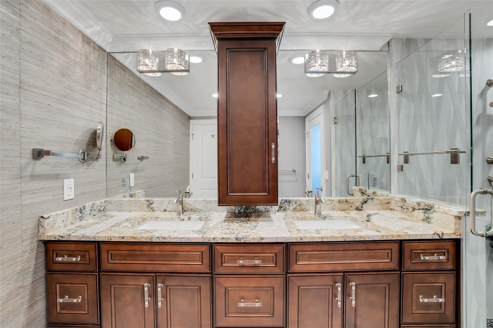 Primary Bathroom with double sinks, matching stone countertops throughout the home, custom soft close solid wood cabinets