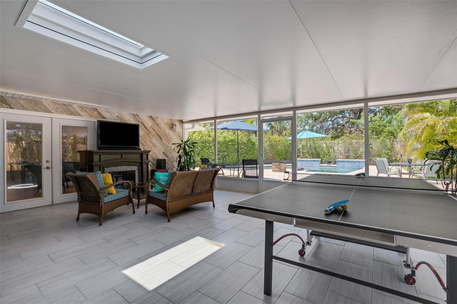 Florida Outdoor living at it's best.  Extremely large screened in back porch with Sauna, Ping Pong table, exercise equipment and TV area.  Don't forget the SkyLight.