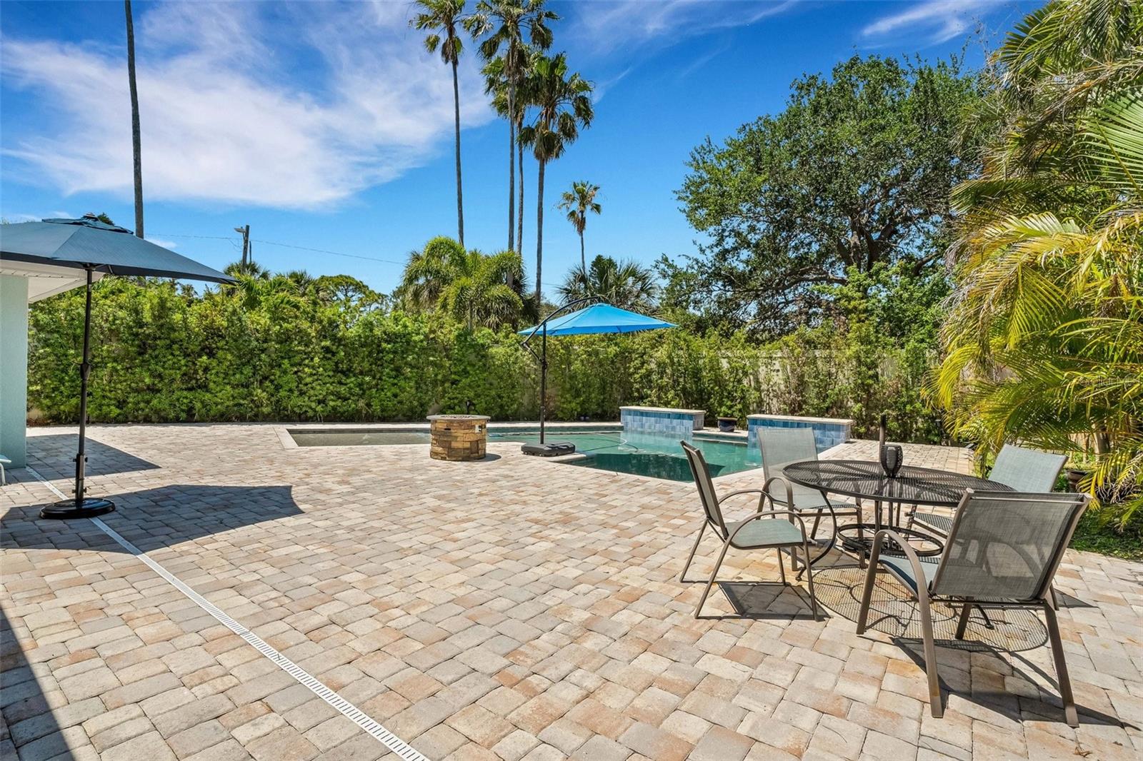 The saltwater, waterfall pool is surrounded by custom pavers.