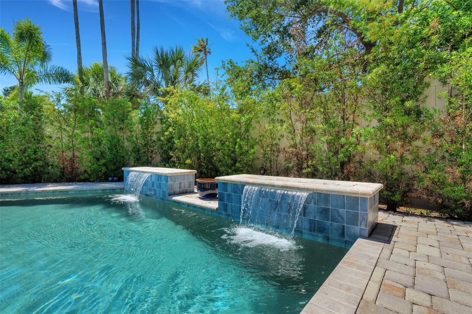 Waterfalls in a Lovely Saltwater Pool! surrounded by the only 7 foot fence in the neighborhood.