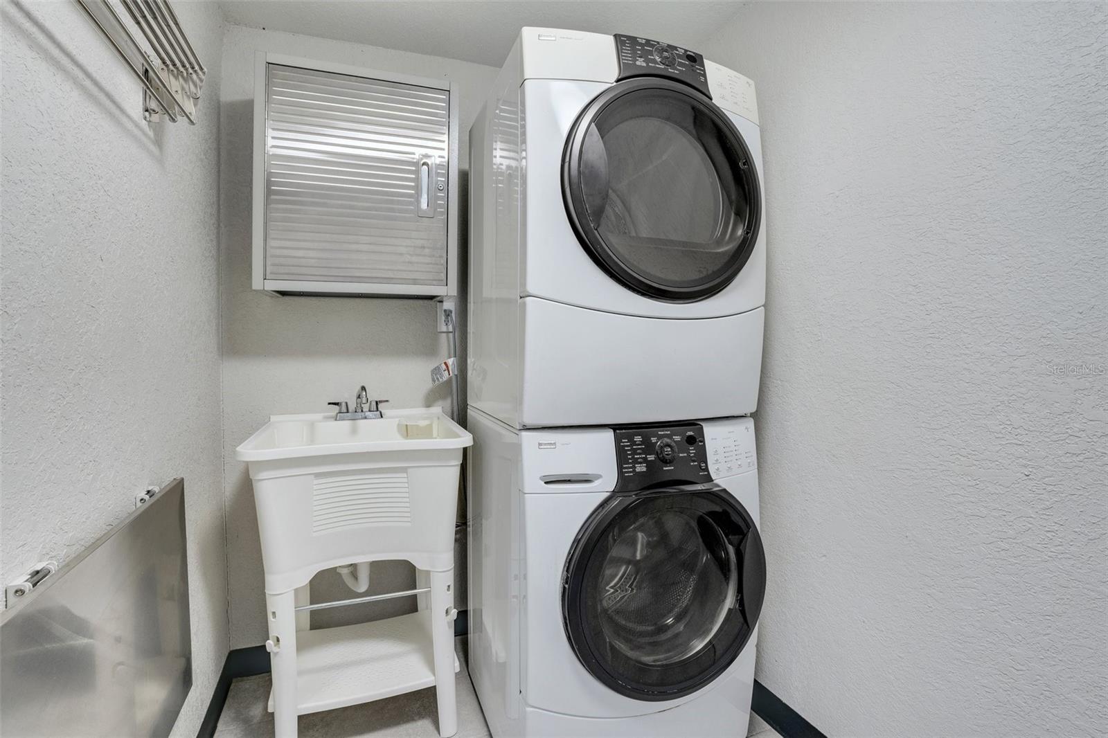 Indoor Laundry room with folding table, sink and stainless cabinet