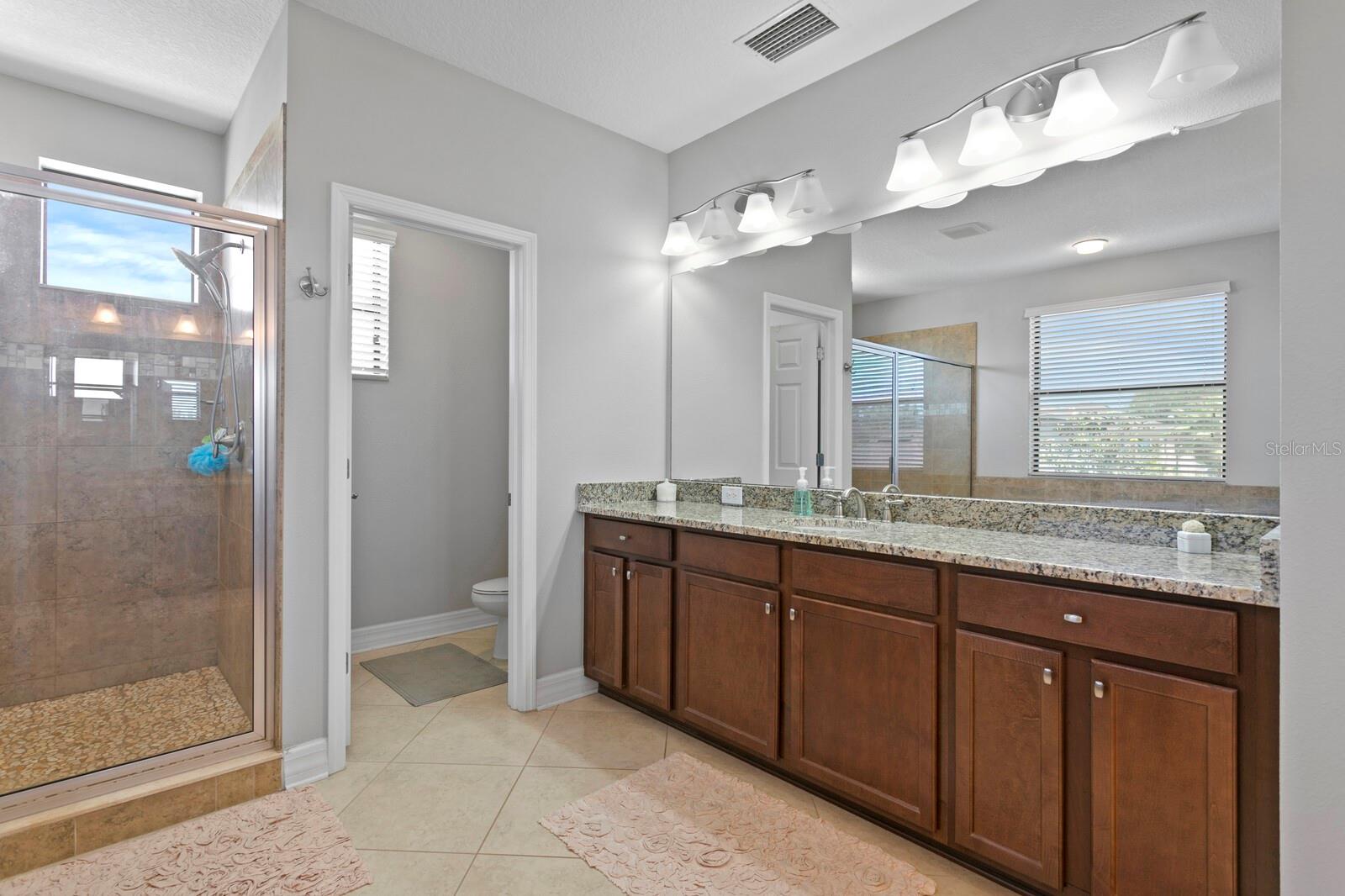 Owners ensuite bathroom has 2 separate vanity areas, tub and shower.