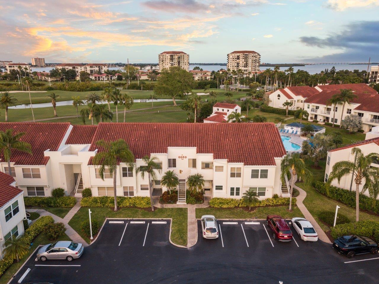 Aerial of building 5B showing the close proximity to the community pool, and the golf and water views.