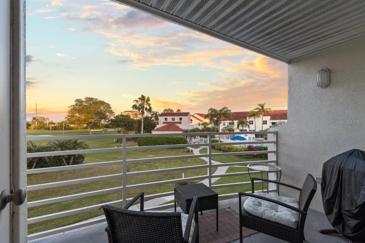 Covered Lanai with water, golf, and community pool views.