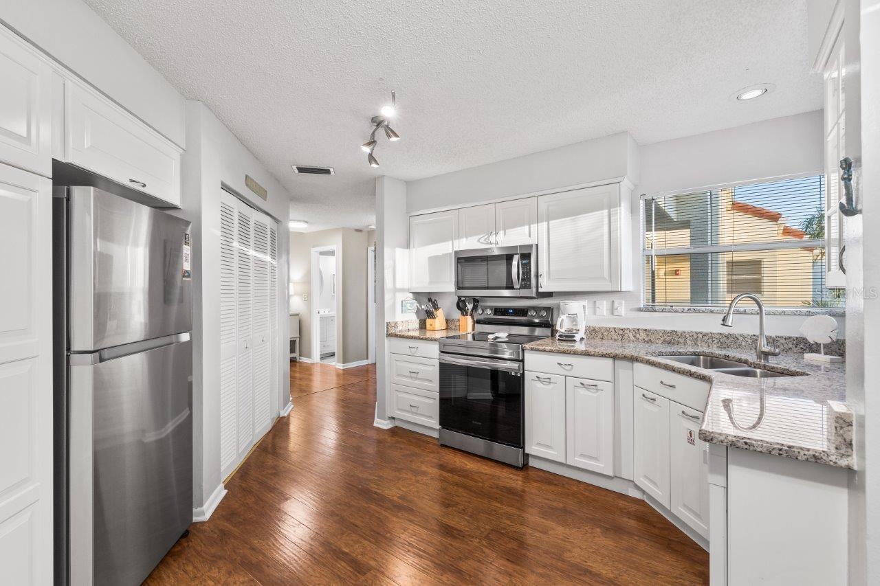 Stunning kitchen featuring ample cabinetry, stainless steel appliances, granite counter tops, and a dinette.